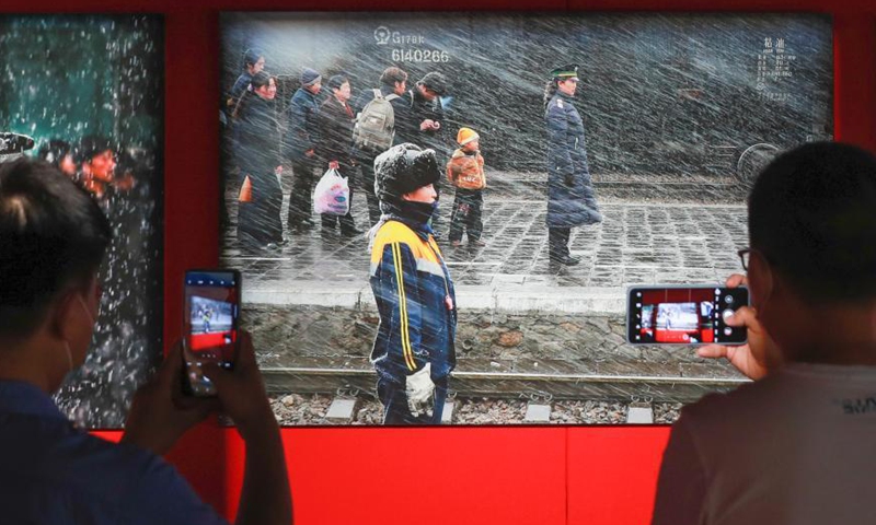 People take photos at the National Railway Photography Exhibition held in China Railway Museum, Beijing, June 8, 2021.  Photo: China News Service