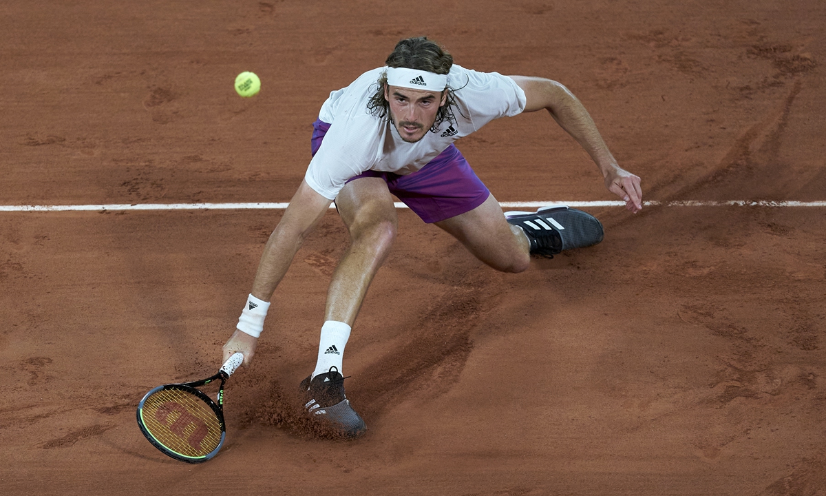 Stefanos Tsitsipas returns a ball in his match against Daniil Medvedev at the the 2021 French Open on Tuesday in Paris. Photo: VCG