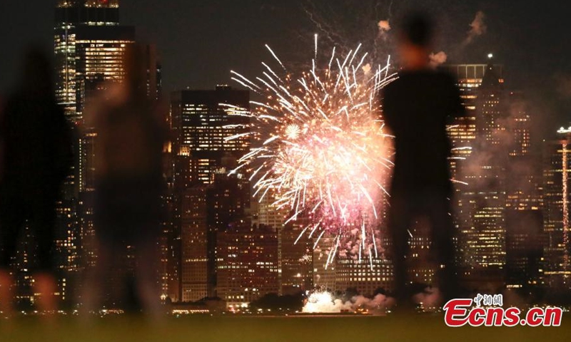 Photo shows fireworks are set off in the New York Harbor, lighting up the skyline on June 15. (Photo/ Liao Pan) 