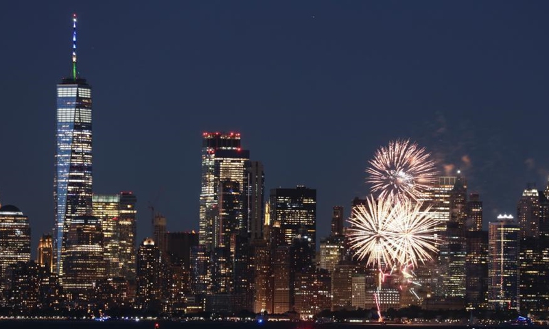 Photo shows fireworks are set off in the New York Harbor, lighting up the skyline on June 15. (Photo/ Liao Pan) 