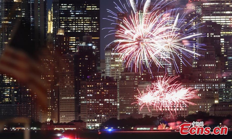 Photo shows fireworks are set off in the New York Harbor, lighting up the skyline on June 15. (Photo/ Liao Pan) 