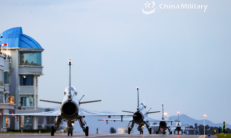 Fighter jets attached to an aviation brigade of the air force under the PLA Southern Theater Command participate in a close formation taxi known as an “ elephant walk” along the runway before takeoff during a round-the-clock flight training exercise on June 16, 2021.(Photo: eng.chinamil.com.cn)