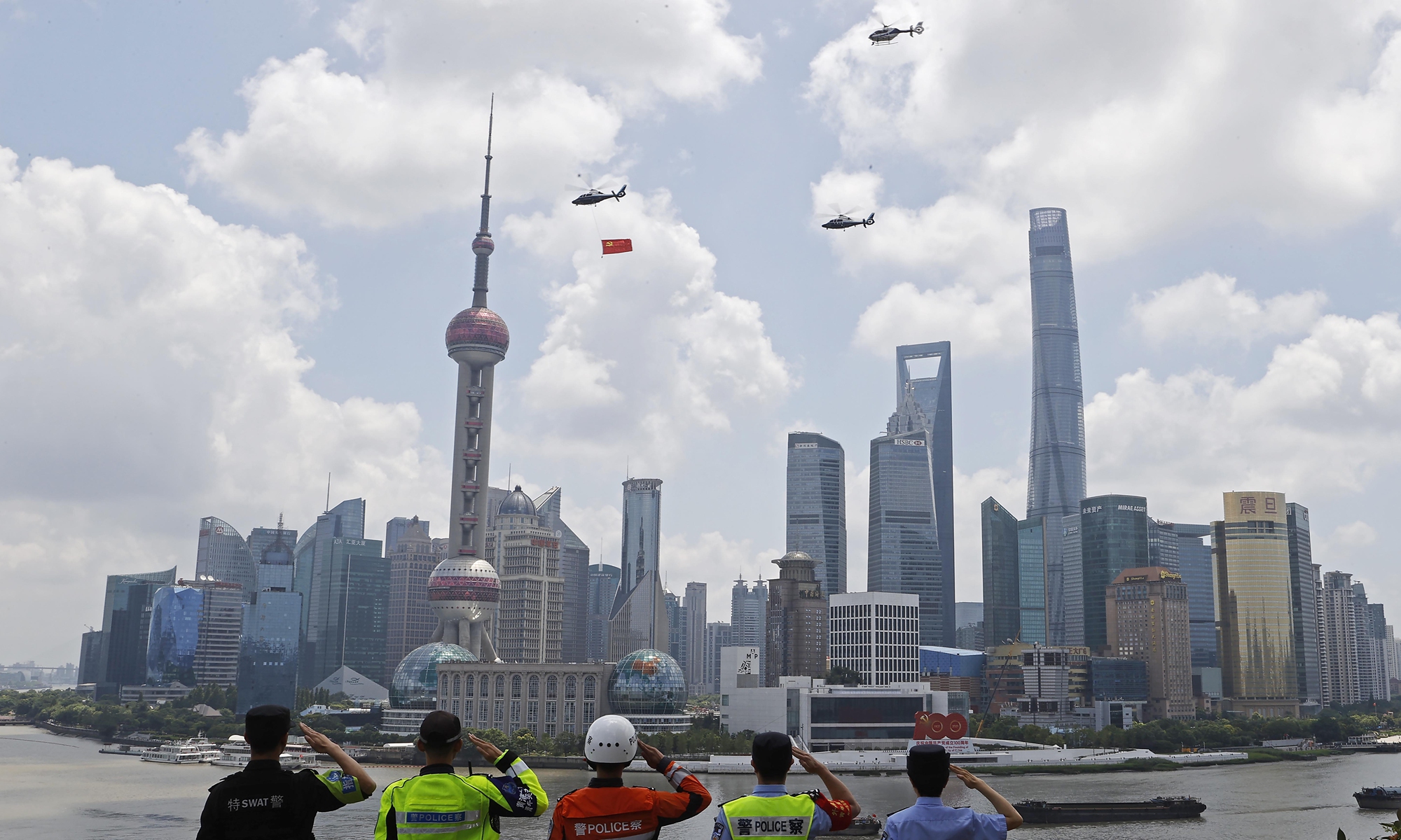 Three police helicopters of the Shanghai Public Security Bureau fly a Party flag over the Huangpu River to celebrate the CPC's centennial in Shanghai on Thursday. Photo: cnsphoto