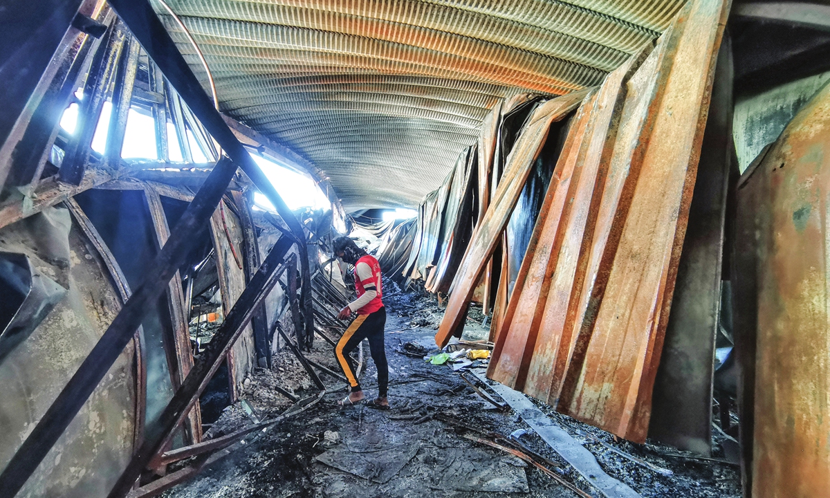 A man looks around at the ravaged coronavirus isolation ward of Al-Hussein hospital after a massive fire overnight engulfed it in the southern Iraqi city of Nasiriyah, on Tuesday. At least 52 people died and 22 were wounded in the fire. Photo: AFP