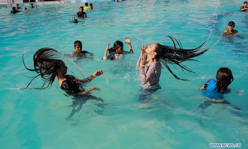 Palestinian children play in a pool to cool off during a hot day at Sharm Park Resort in Gaza City, on July 4, 2021.(Photo: Xinhua)