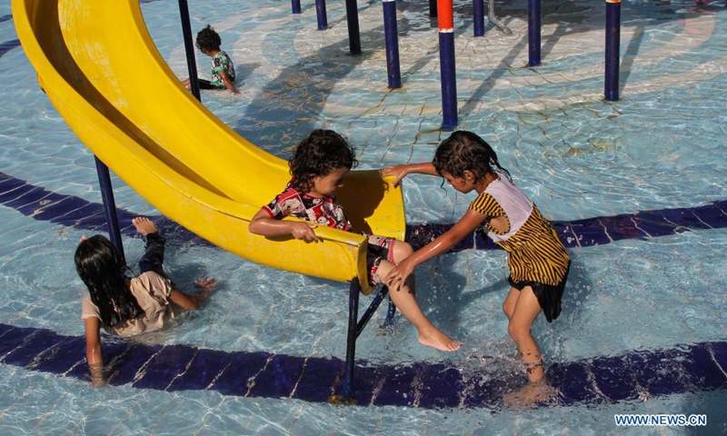 Palestinian children play in a pool to cool off during a hot day at Sharm Park Resort in Gaza City, on July 4, 2021.(Photo: Xinhua)