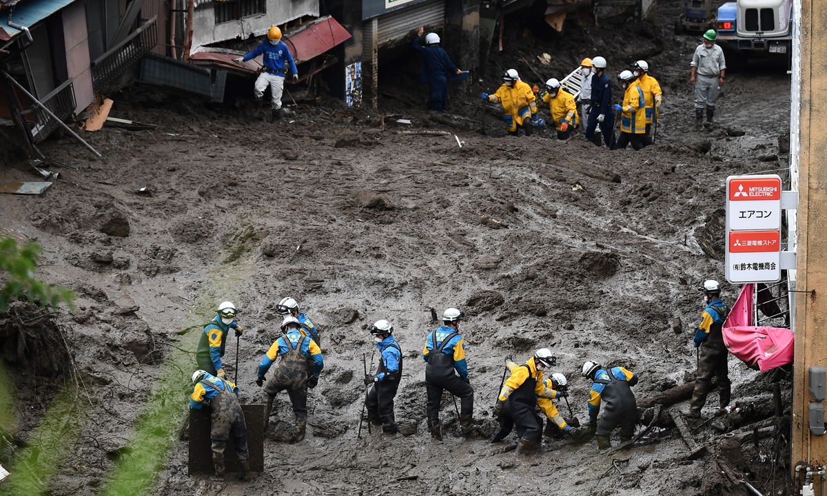 Japanese police search for missing people buried under mud at the scene of a landslide following days of heavy rain in Atami in Shizuoka Prefecture, Japan on Monday. Photo: AFP