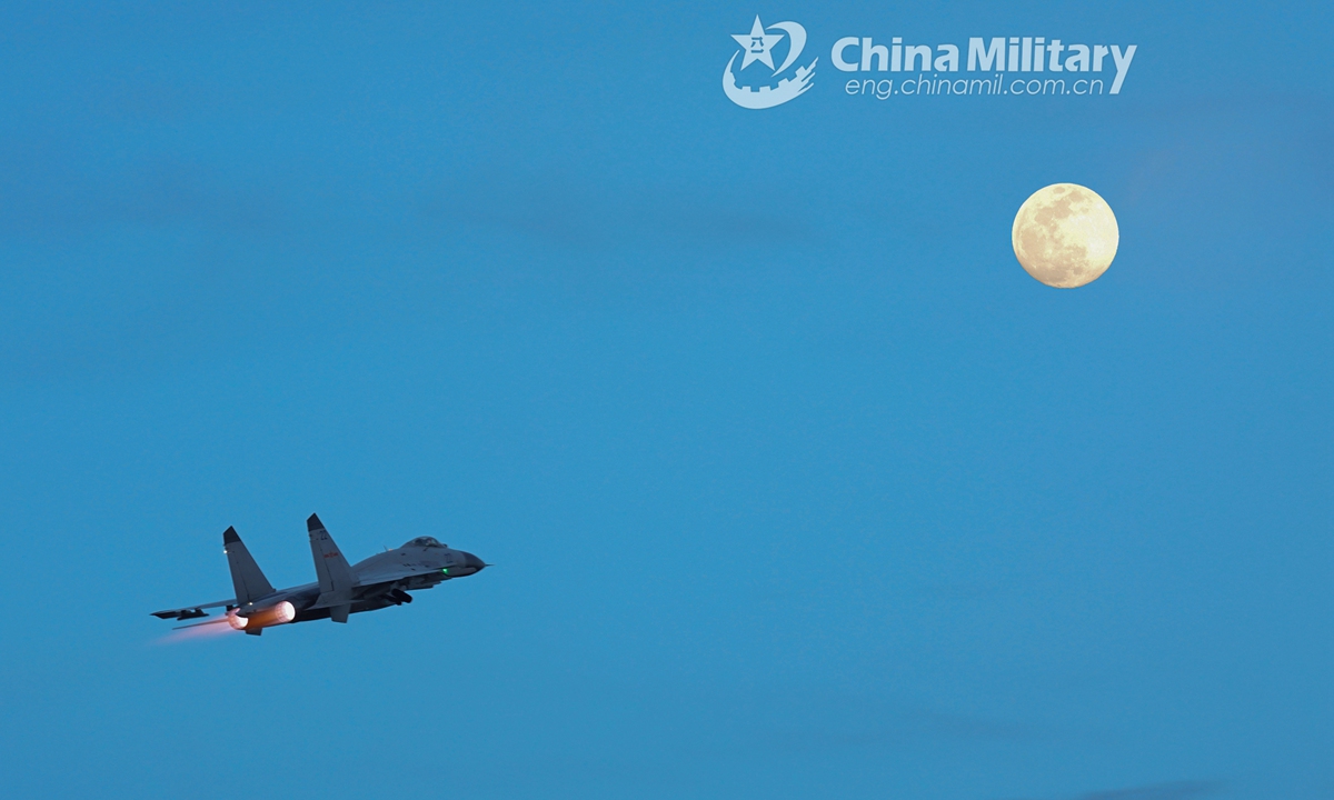 The double-exposed shot shows a fighter jet silhouetted against a full moon at night during a 24-hour flight training exercise organized by an aviation brigade with the navy under the PLA Southern Theater Command. The round-the-clock training exercise focused on subjects including free aerial combat, seizing air-superiority operation, and assault covering operation.Photo:China Military