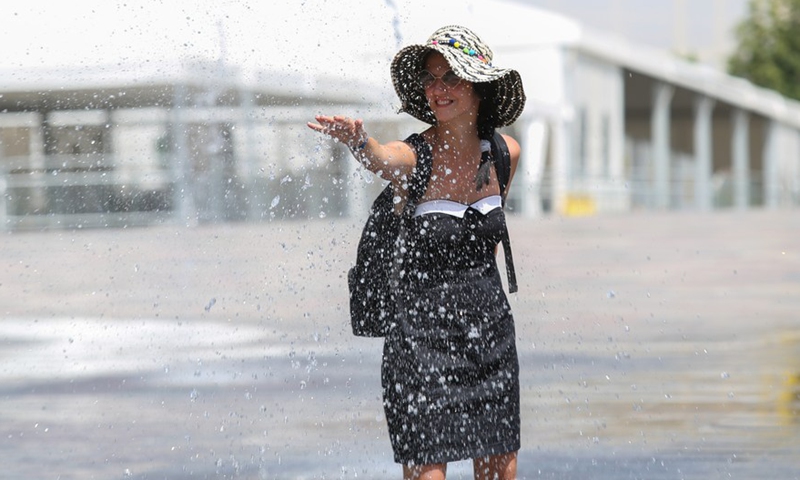 A woman cools off in fountains at Skanderbeg Square in the center of capital Tirana, Albania, July 29, 2021.Photo:Xinhua