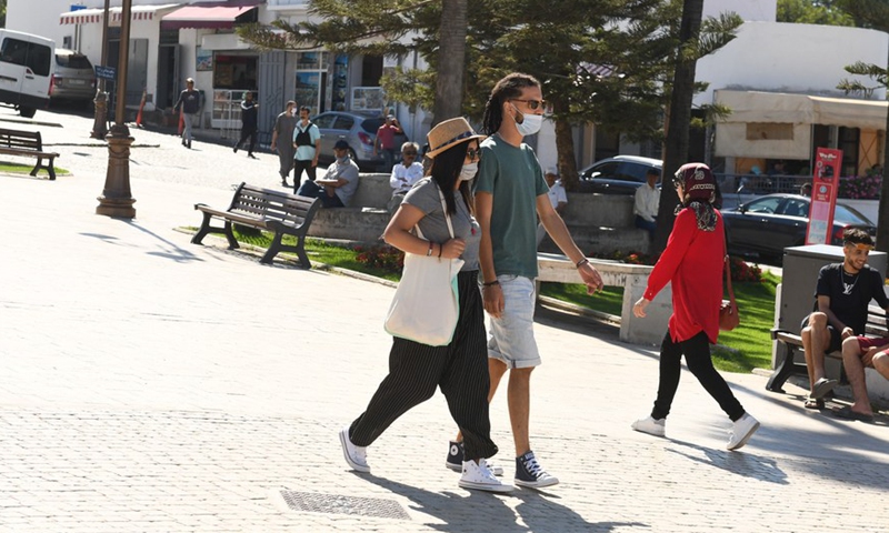 People wearing face masks walk on a street in Tangier, Morocco, on July 15, 2021.Photo:Xinhua