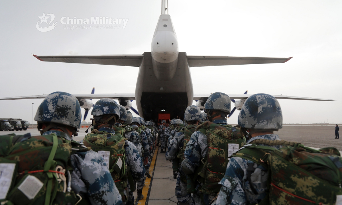 Paratroopers assigned to a brigade under the PLA Air Force’s airborne troops board a transport aircraft in order during a parachute training exercise in mid-July, 2021. (eng.chinamil.com.cn/Photo by Liu Huan)