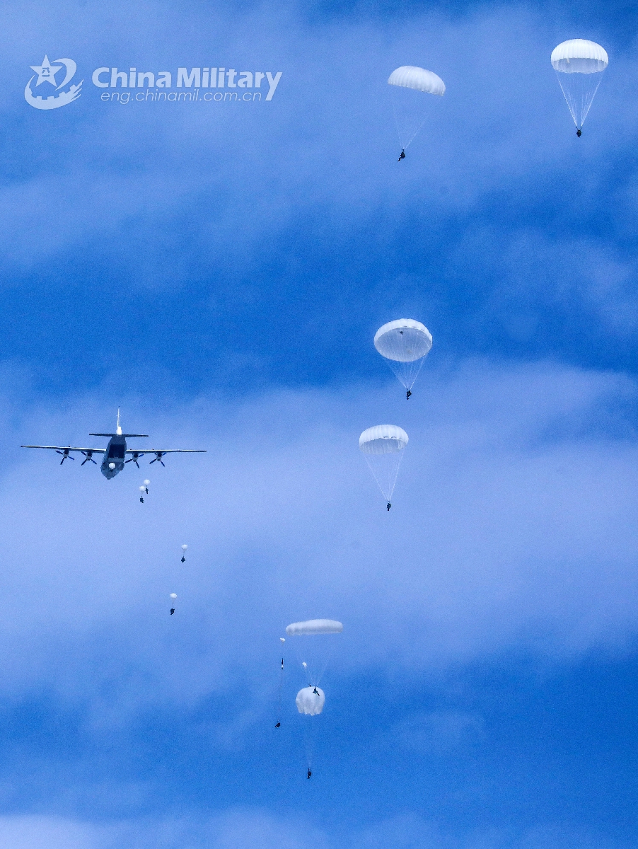 Paratroopers assigned to a brigade under the PLA Air Force’s airborne troops descend to the drop zone after jumping from a transport aircraft during a parachute training exercise in mid-July, 2021. (eng.chinamil.com.cn/Photo by Liu Huan)