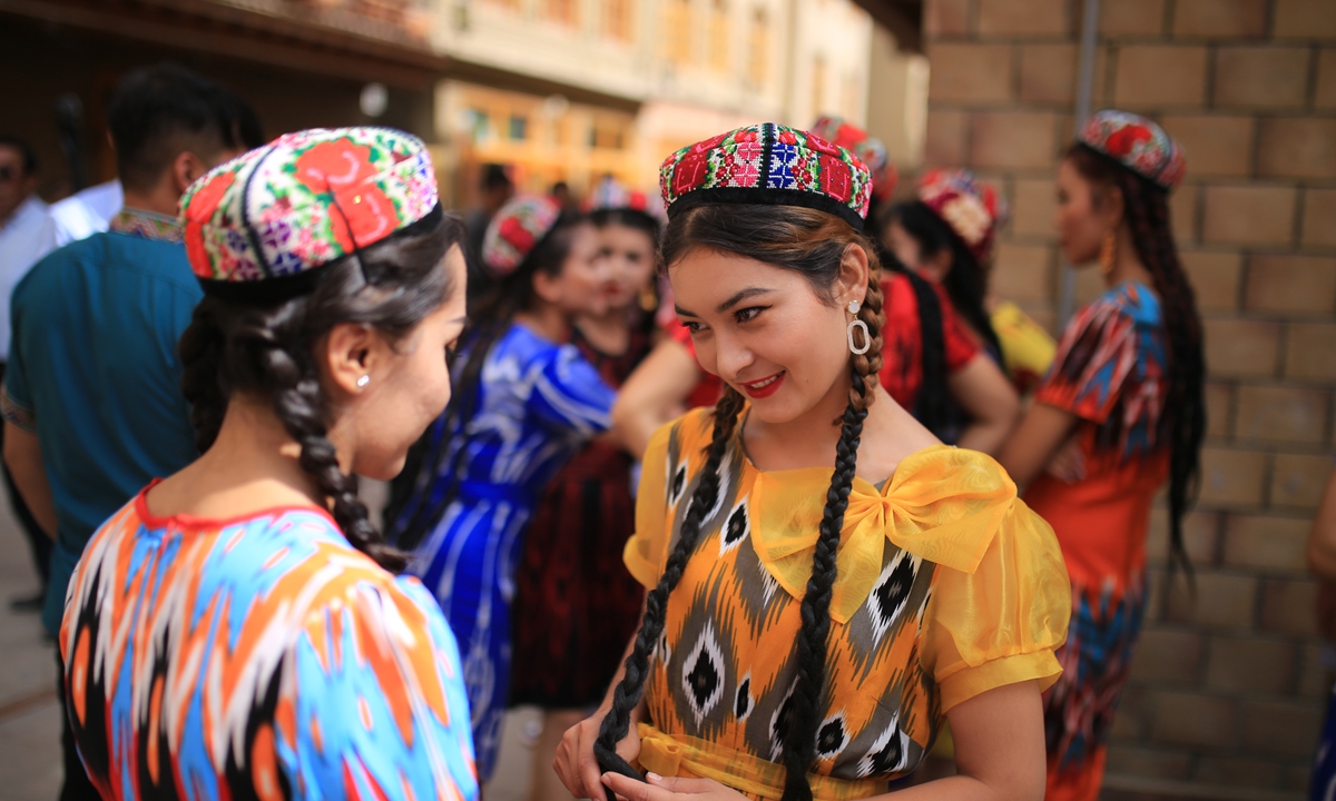 Two girls dress up for the Corban Festival in Hotan Prefecture. Photo: Fan Lingzhi/GT