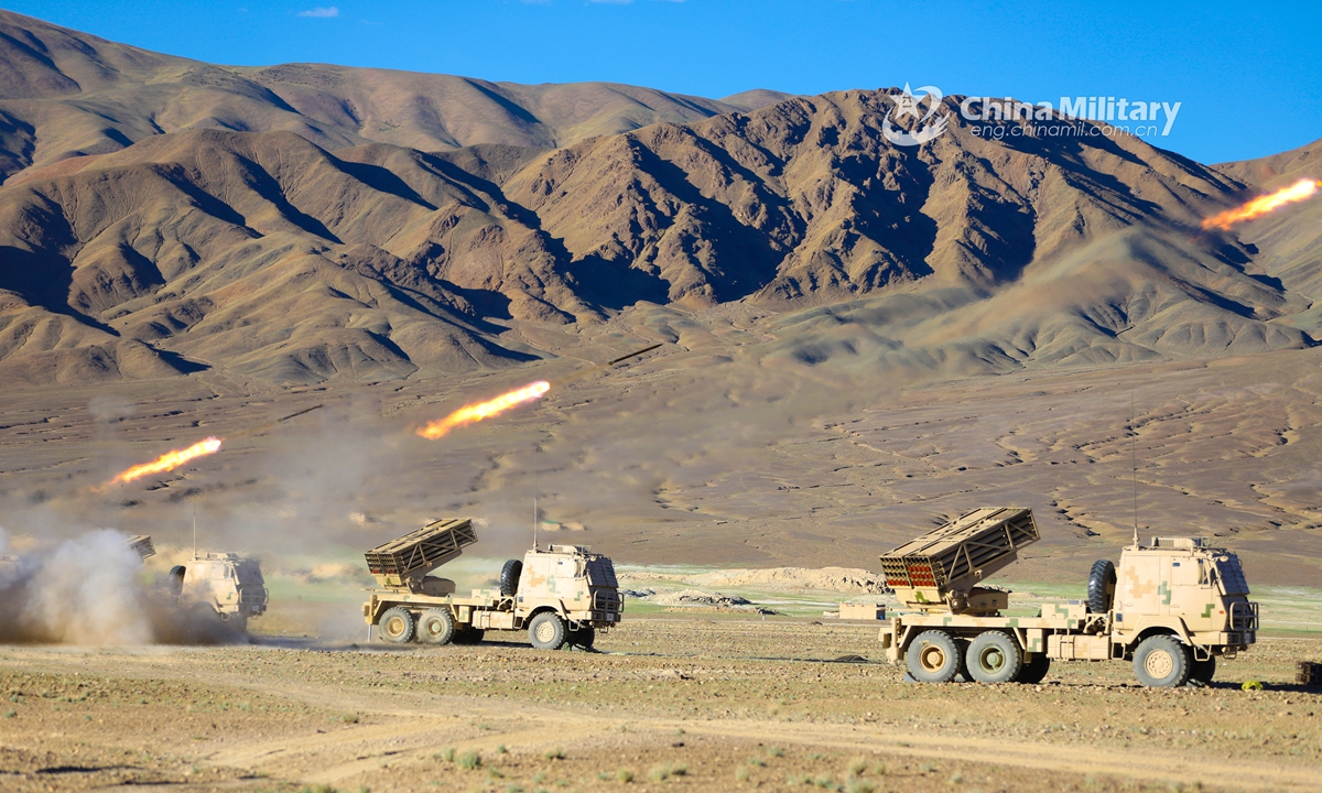 Truck-mounted long-range multiple launch rocket systems (LRMLRS) attached to an artillery detachment with a regiment under the PLA Army fire rockets at mock ground targets during a live-fire test in July of 2021. (eng.chinamil.com.cn/Photo by Xiang Xudong)