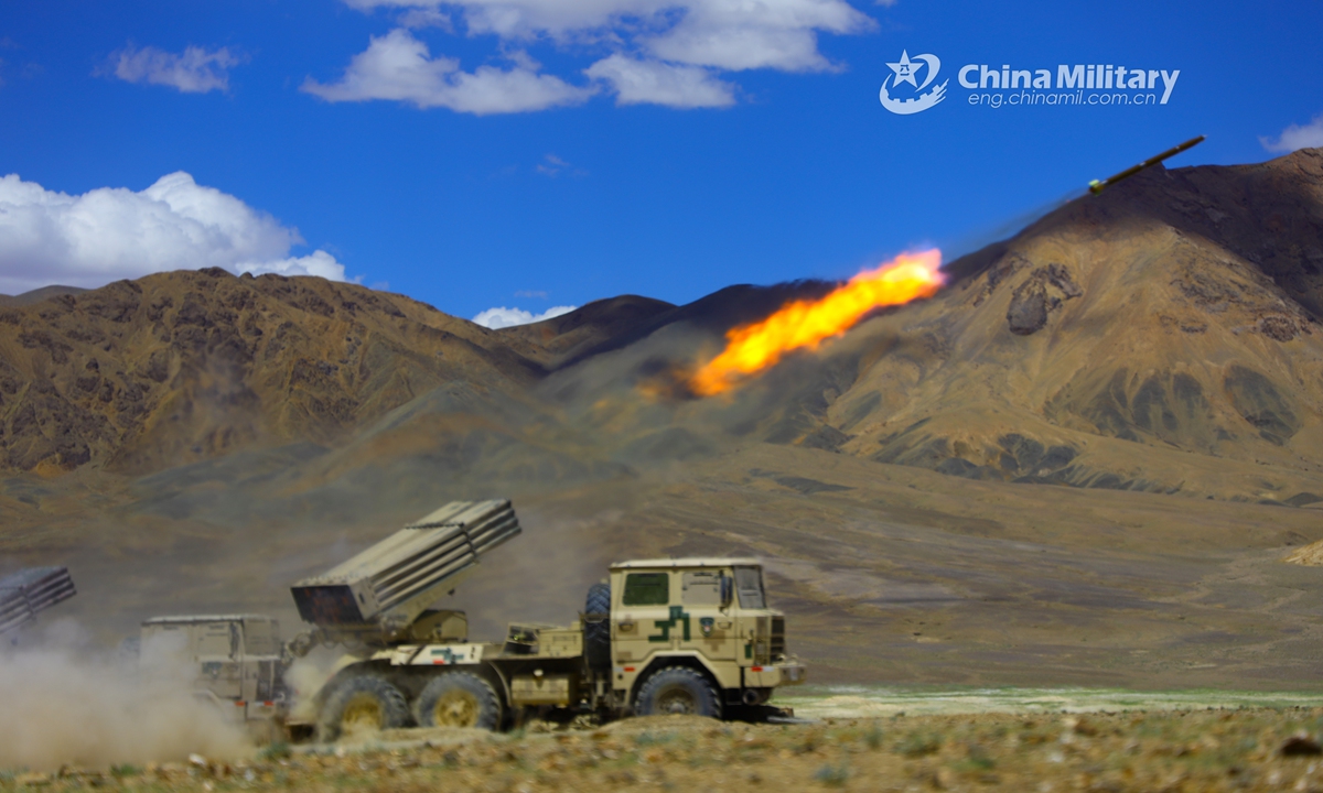 A truck-mounted long-range multiple launch rocket system (LRMLRS) attached to an artillery detachment with a regiment under the PLA Army fires a rocket against the mock target during a live-fire test in July of 2021. (eng.chinamil.com.cn/Photo by Xiang Xudong)