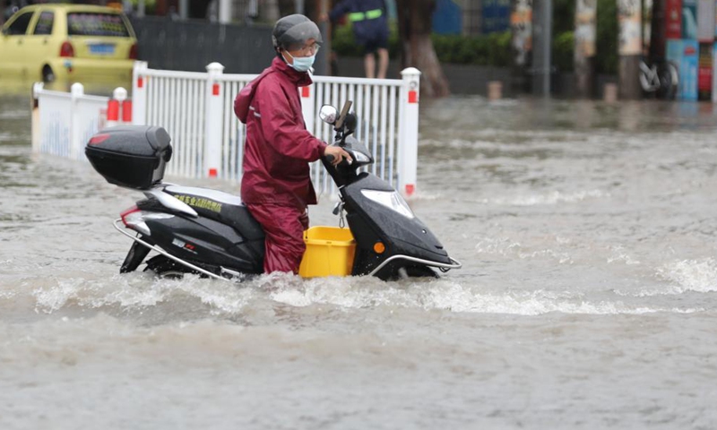 A citizen wades through a waterlogged road on a motorcycle in Jimei District of Xiamen, southeast China's Fujian Province, Aug. 5, 2021. Typhoon Lupit made its second landfall on Thursday in Fujian Province, bringing heavy downpours and forcing the evacuation of thousands. The local government has initiated an emergency response to flood and waterlogging amid torrential rains brought by Lupit.Photo:Xinhua