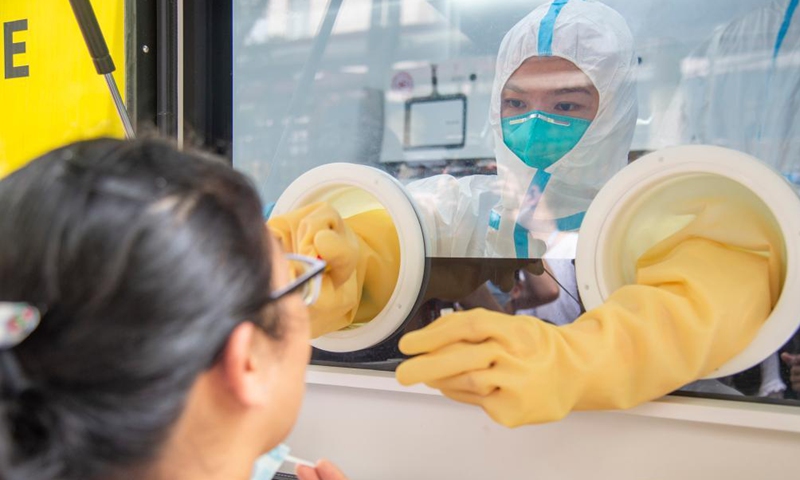 A medical worker works in a mobile lab for COVID-19 nucleic acid testing in Wuchang District of Wuhan, central China's Hubei Province, Aug. 5, 2021.Photo:Xinhua