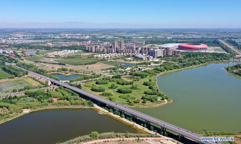 Aerial photo taken on Aug. 5, 2021 shows the water-surrounded Qingtongxia City, northwest China's Ningxia Hui Autonomous Region. (Xinhua/Wang Peng)