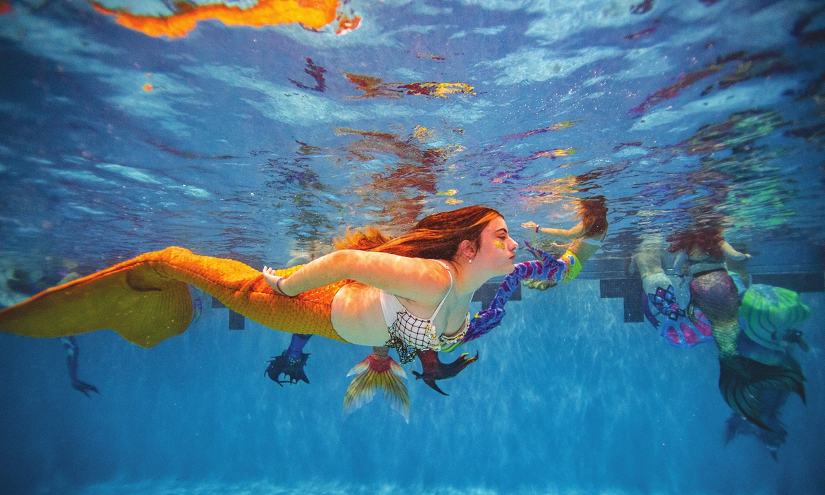 Mermaid hobbyists take part in an open swim during MerMagic convention at an aquatic center in Manassas, Virginia on Sunday. Photo: AFP