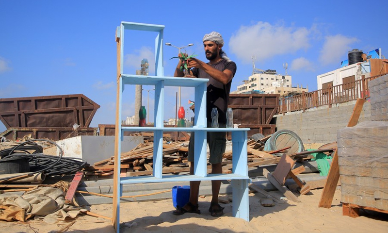 A Palestinian young man is seen working at an eco-friendly cafe on the beach of the Mediterranean Sea in Gaza city on July 28, 2021.(Photo: Xinhua)