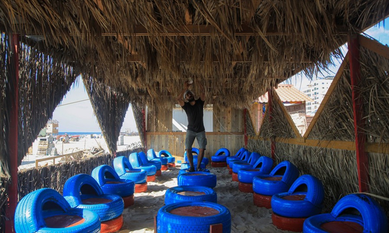 A Palestinian young man is seen working at an eco-friendly cafe on the beach of the Mediterranean Sea in Gaza city on July 28, 2021.(Photo: Xinhua)