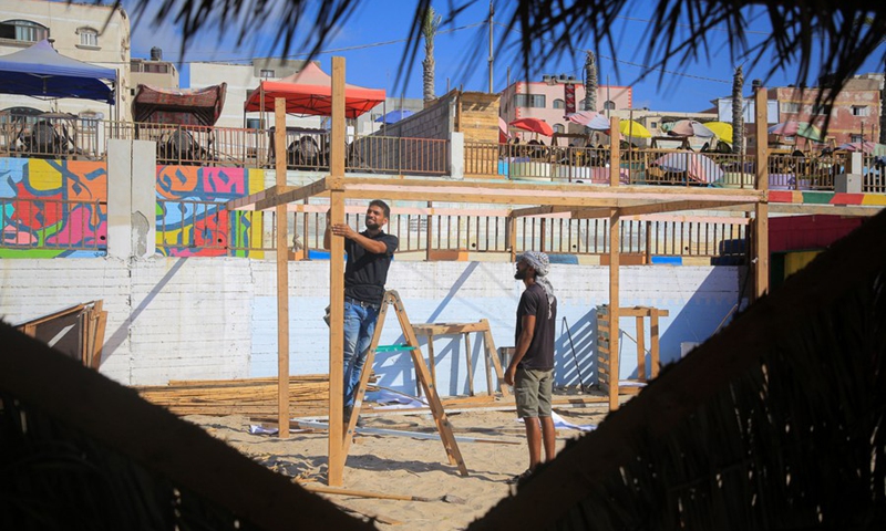 Palestinian young men are seen working at an eco-friendly cafe on the beach of the Mediterranean Sea in Gaza city on July 28, 2021.(Photo: Xinhua)