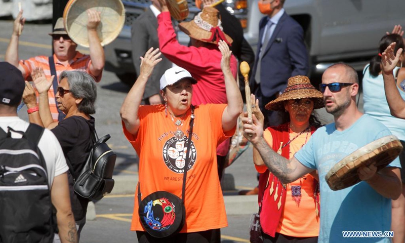 People sing after a news conference at the site of the former St. Paul Indian Residential School in North Vancouver, British Columbia, Canada, on Aug. 10, 2021. Three British Columbia First Nations said they will work together to investigate the disappearance of indigenous children at the site of the former St. Paul's Indian Residential School in North Vancouver on Tuesday.(Phhoto: Xinhua)