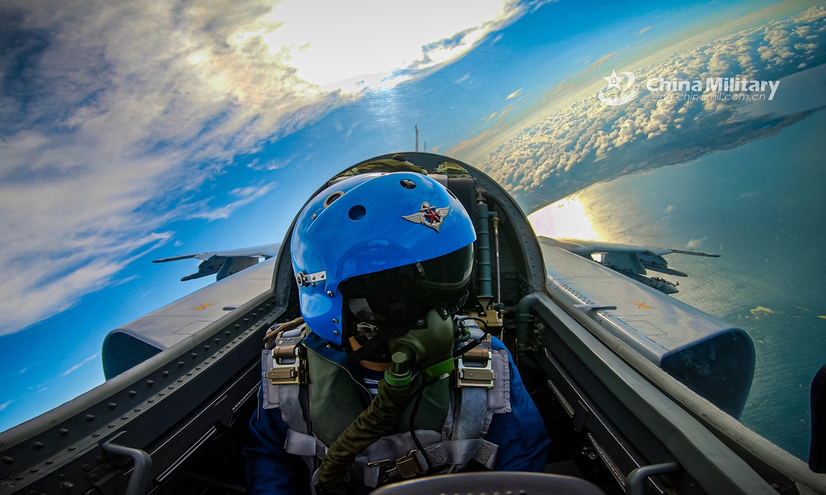 A pilot assigned to a naval aviation brigade under the PLA Northern Theater Command manages the lift and controls the roll of a fighter bomber during a round-the-clock flight training exercise in late July. (eng.chinamil.com.cn/Photo by Li Mingxi and Liu Xuhong)