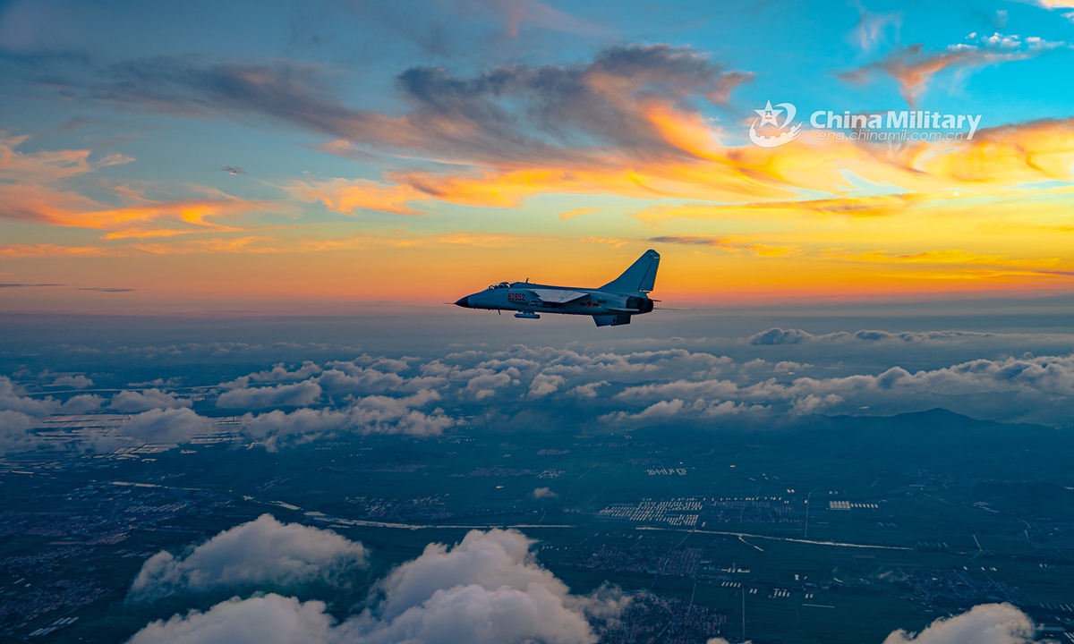 A fighter bomber attached to a naval aviation brigade under the PLA Northern Theater Command pierces into the stratosphere through clouds and mist during a round-the-clock flight training exercise in late July. (eng.chinamil.com.cn/Photo by Li Mingxi and Liu Xuhong)