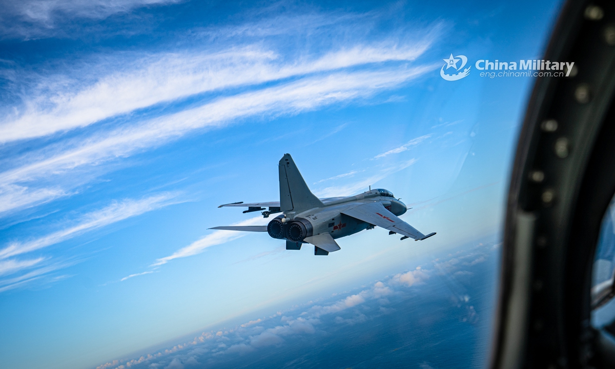 A pilot assigned to a naval aviation brigade under the PLA Northern Theater Command manages the lift and controls the roll of a fighter bomber during a round-the-clock flight training exercise in late July. (eng.chinamil.com.cn/Photo by Li Mingxi and Liu Xuhong)