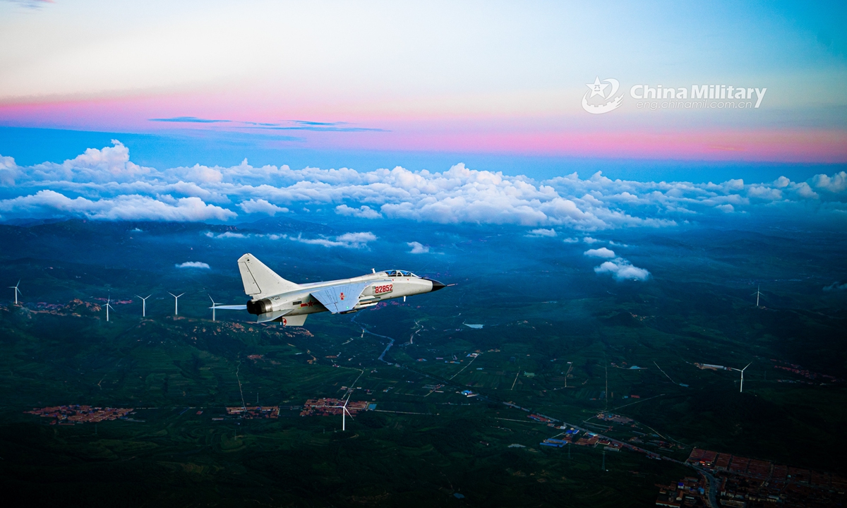 A fighter bomber attached to a naval aviation brigade under the PLA Northern Theater Command pierces into the stratosphere through clouds and mist during a round-the-clock flight training exercise in late July. (eng.chinamil.com.cn/Photo by Li Mingxi and Liu Xuhong)