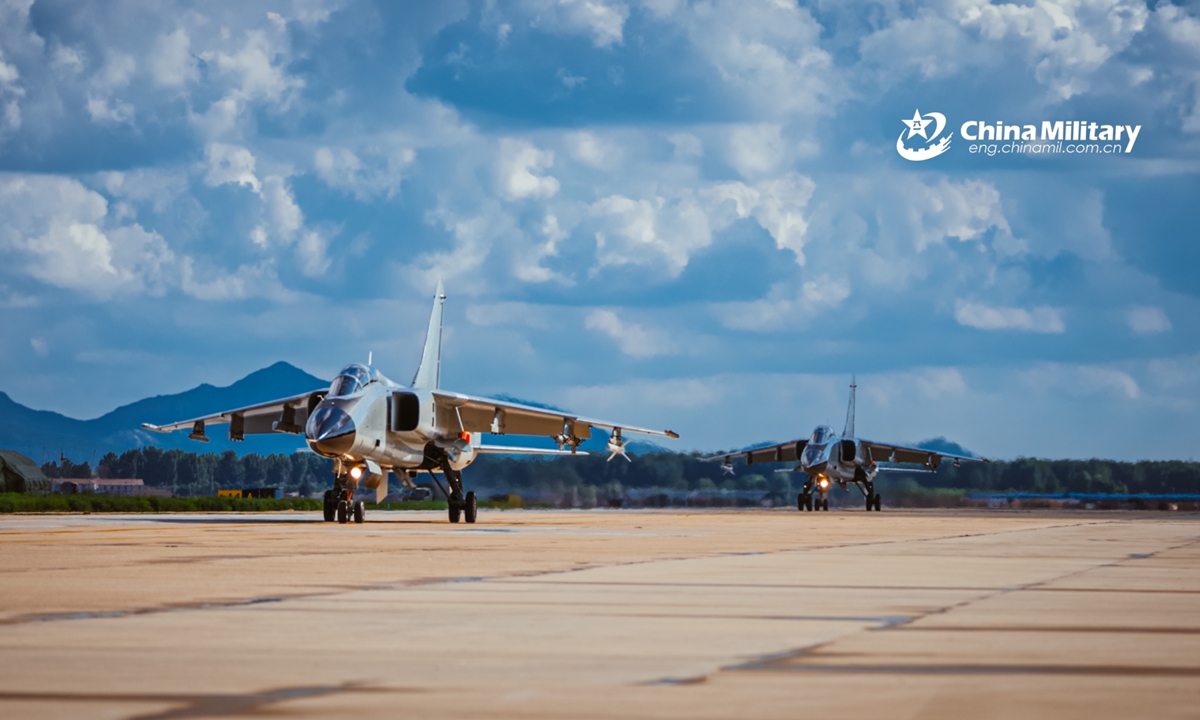 Two fighter bombers attached to a naval aviation brigade under the PLA Northern Theater Command taxi on the runway in close formation before takeoff for a round-the-clock flight training exercise in late July. (eng.chinamil.com.cn/Photo by Li Mingxi and Liu Xuhong)