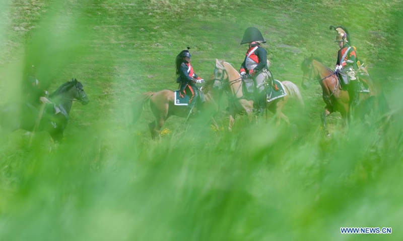 Riders take part in a cavalry competition on the site of Battle of Waterloo, in Braine-l'Alleud, Belgium, Aug. 14, 2021. A cavalry competition named Memorial Trophy was organized by the Waterloo 1815 Memorial on the site of Battle of Waterloo on Saturday and Sunday. During the competition, some 30 riders will compete in several events like orienteering race, cavalry charge demonstrations, saber exercises while riding the horse, etc. (Xinhua/Zhang Cheng)
