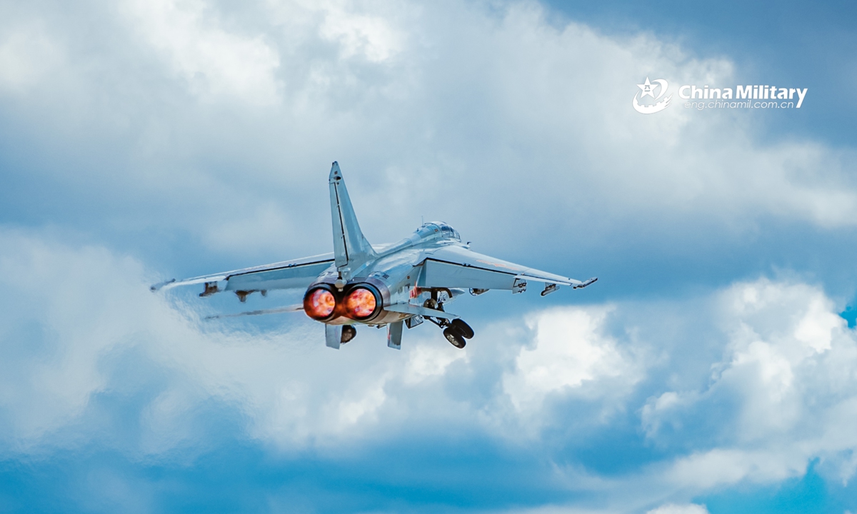 A fighter bomber attached to a naval aviation brigade under the PLA Northern Theater Command pierces into the stratosphere through clouds and mist during a round-the-clock flight training exercise in late July. (eng.chinamil.com.cn/Photo by Li Mingxi and Liu Xuhong)