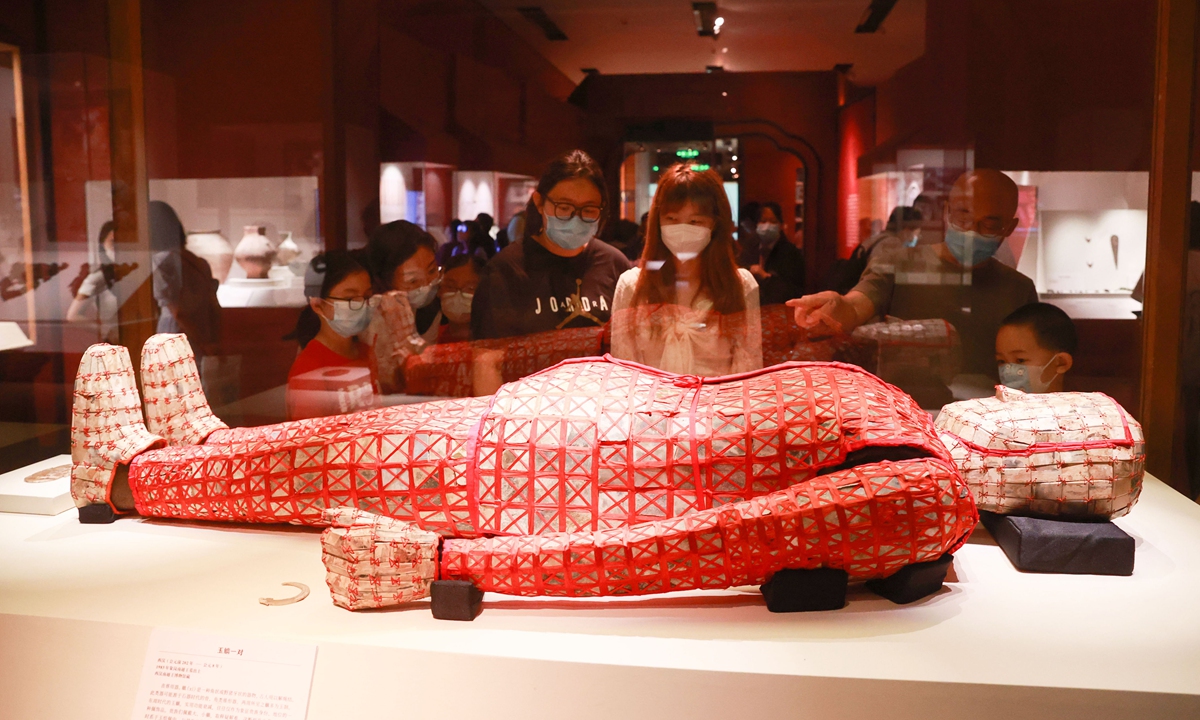 Visitors examine a jade suit in the National Museum of China on August 15. The suit is one of the representative relics on display during an exhibition starting August 10 that features archaeological finds from ancient China's Qin (221BC-206BC) and Han (206BC-AD220) dynasties. The relics were excavated in Guangzhou, South China's Guangdong Province. 
Photo: VCG