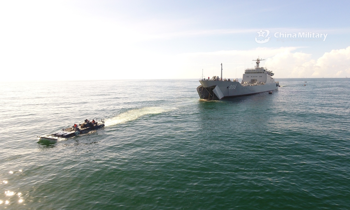 Amphibious armored vehicles attached to a brigade of the PLA Navy Marine Corps practice entering and leaving the well deck of the floating tank landing ship during a maritime training exercise in mid July, 2021. (eng.chinamil.com.cn/Photo by Liu Yuxiang)