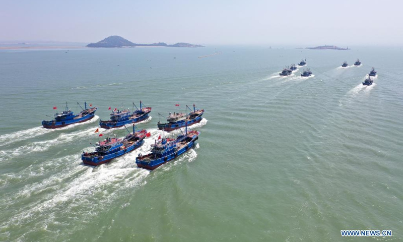 Aerial photo taken on Aug. 16, 2021 shows fishing boats sailing from a port in Jinjiang City of Quanzhou, southeast China's Fujian Province. A three-and-a-half-month seasonal fishing ban on the sea area of the province was lifted on Monday.(Photo: Xinhua)