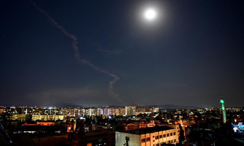 A trail of smoke is seen in the sky over Damascus, Syria, on Aug. 19, 2021. Israel launched missile strikes at some sites in Damascus and the central province of Homs on Thursday night, Syrian state TV reported. Photo:Xinhua