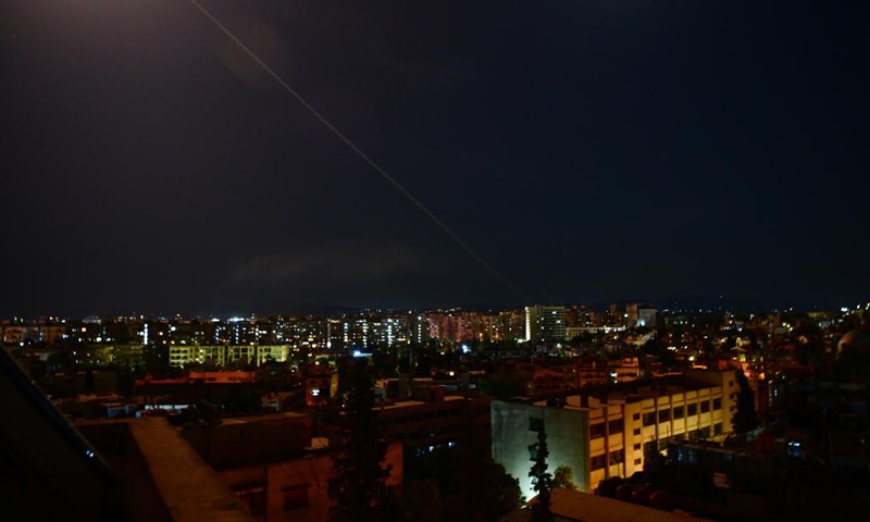 A trail of smoke is seen in the sky over Damascus, Syria, on Aug. 19, 2021. Israel launched missile strikes at some sites in Damascus and the central province of Homs on Thursday night, Syrian state TV reported. Photo:Xinhua