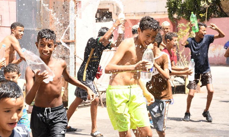 Children play with water on Ashura in Rabat, Morocco - Global Times