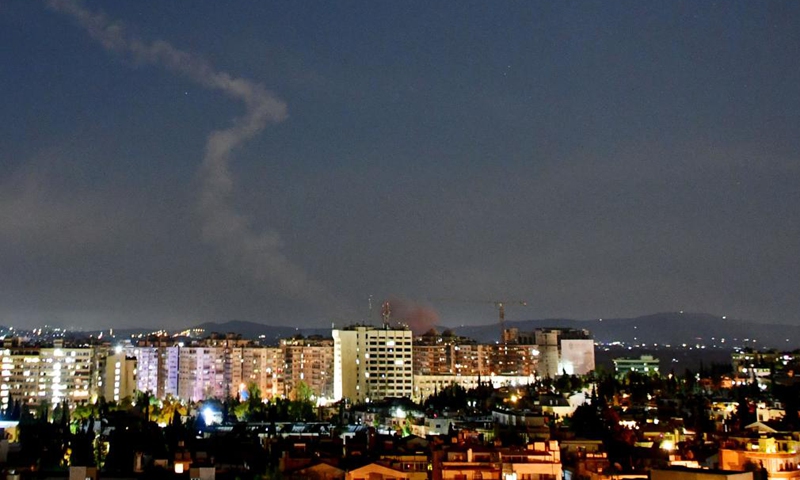 A trail of smoke is seen in the sky over Damascus, Syria, on Aug. 19, 2021. Israel launched missile strikes at some sites in Damascus and the central province of Homs on Thursday night, Syrian state TV reported. Photo:Xinhua