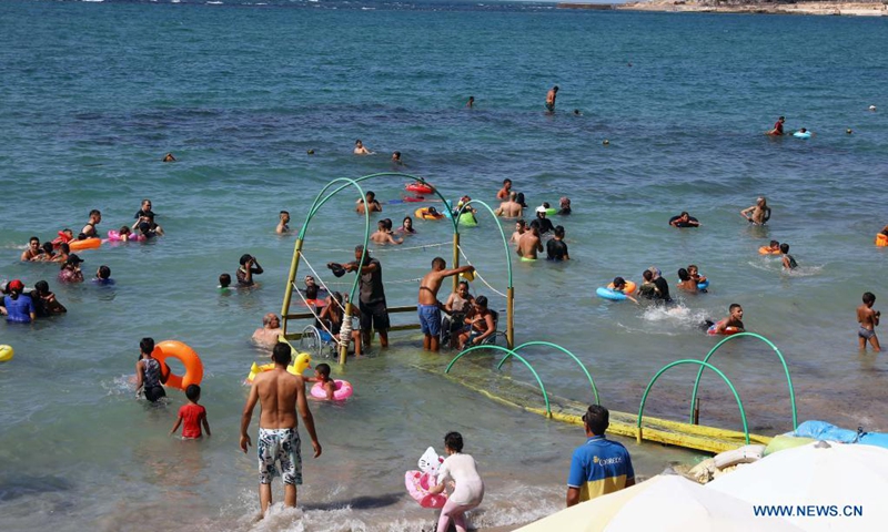 People enjoy themselves on a disability-friendly public beach in Alexandria, Egypt, on Aug. 17, 2021.(Photo: Xinhua)