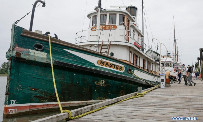 People visit vintage ships at the dock during the 18th annual Maritime Festival in Richmond, British Columbia, Canada, on Aug. 21, 2021. The 18th annual Richmond Maritime Festival, which runs from Aug. 21 to Aug. 22, showcases the cultural and maritime heritage with historical artefacts, maritime exhibits and performances.(Photo: Xinhua)