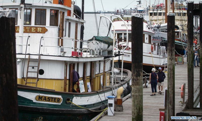 People visit vintage ships at the dock during the 18th annual Maritime Festival in Richmond, British Columbia, Canada, on Aug. 21, 2021. The 18th annual Richmond Maritime Festival, which runs from Aug. 21 to Aug. 22, showcases the cultural and maritime heritage with historical artefacts, maritime exhibits and performances.(Photo: Xinhua)