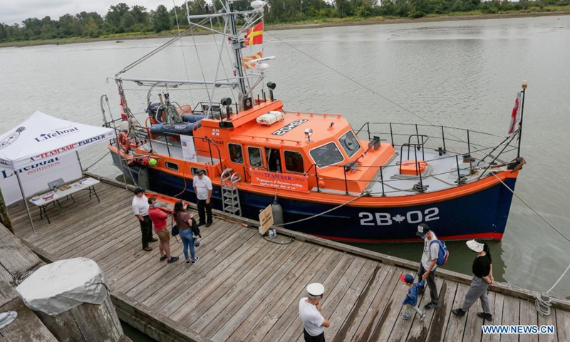 People visit a rescue boat at the dock during the 18th annual Maritime Festival in Richmond, British Columbia, Canada, on Aug. 21, 2021. The 18th annual Richmond Maritime Festival, which runs from Aug. 21 to Aug. 22, showcases the cultural and maritime heritage with historical artefacts, maritime exhibits and performances(Photo: Xinhua)