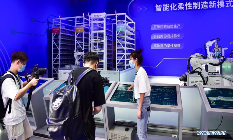 Journalists work at the venue of the 2021 Smart China Expo in southwest China's Chongqing Municipality, Aug. 22, 2021. The 2021 Smart China Expo, set to be held from Aug. 23 to 25 in Chongqing, aims to promote exchanges in smart technologies and international cooperation in the smart industry.Photo: Xinhua