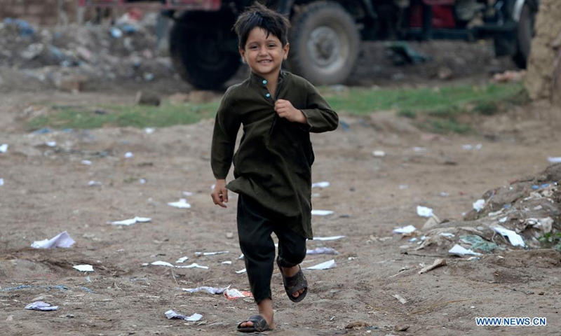 An Afghan boy plays on the outskirts of Islamabad, capital of Pakistan, Aug. 22, 2021.Photo: Xinhua