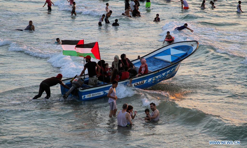 Palestinians spend time at sunset in the Mediterranean Sea off Gaza coast in Gaza City, on Aug. 20, 2021.(Photo: Xinhua)