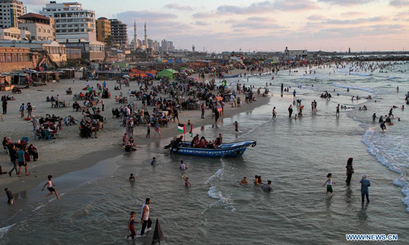 Palestinians spend time at sunset in the Mediterranean Sea off Gaza coast in Gaza City, on Aug. 20, 2021.(Photo: Xinhua)