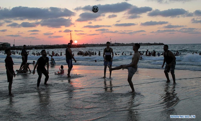 Palestinians spend time at sunset in the Mediterranean Sea off Gaza coast in Gaza City, on Aug. 20, 2021.(Photo: Xinhua)